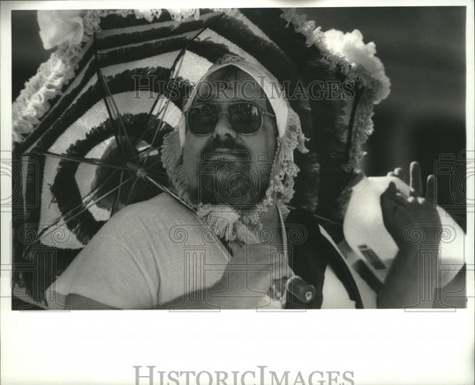 1988 Mardi Gras Masker Steve "Mad Dog" Migliore dons baby costume. - Historic Images