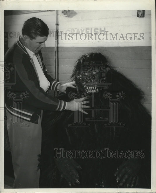 Harold Morgan adjusts gorilla headpiece on Roy Dollinger - Historic Images