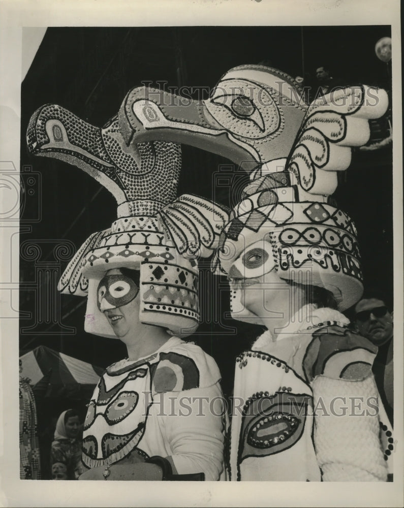 1965 Mardi Gras celebrators in intricate bird headgear costumes - Historic Images