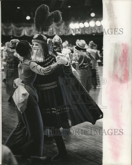 1976 Masker Chooses Dancing Partner as Festivities Begin - Historic Images