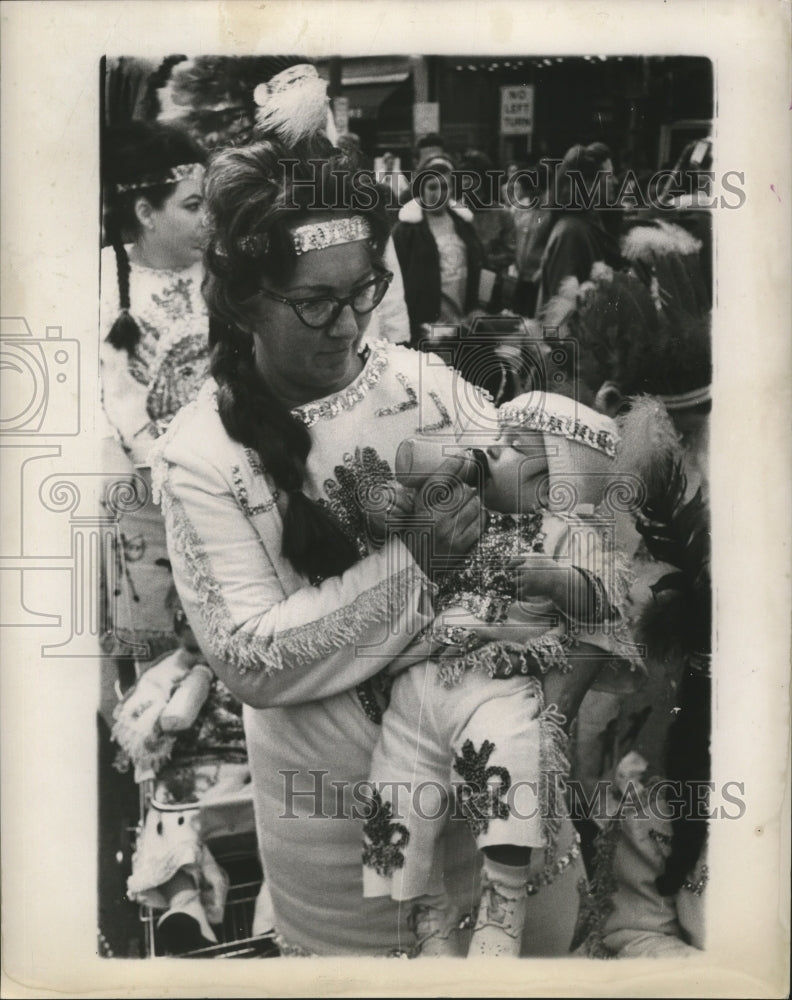 1966 Attendees Feeds Baby during Mardi Gras, New Orleans  - Historic Images