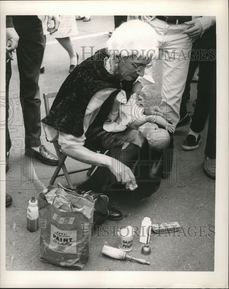 1965 Carnival Masker Holding a Baby Doll in New Orleans  - Historic Images