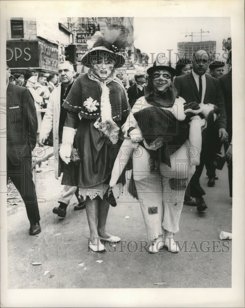 1965 Two Carnival Maskers Walk Among Crowd in New Orleans - Historic Images