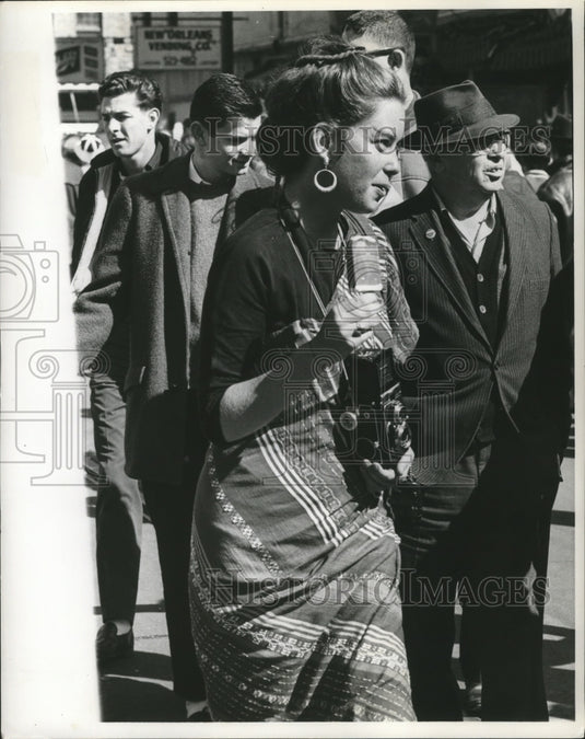 1964 Lady Taking Pictures of Carnival Maskers in New Orleans - Historic Images