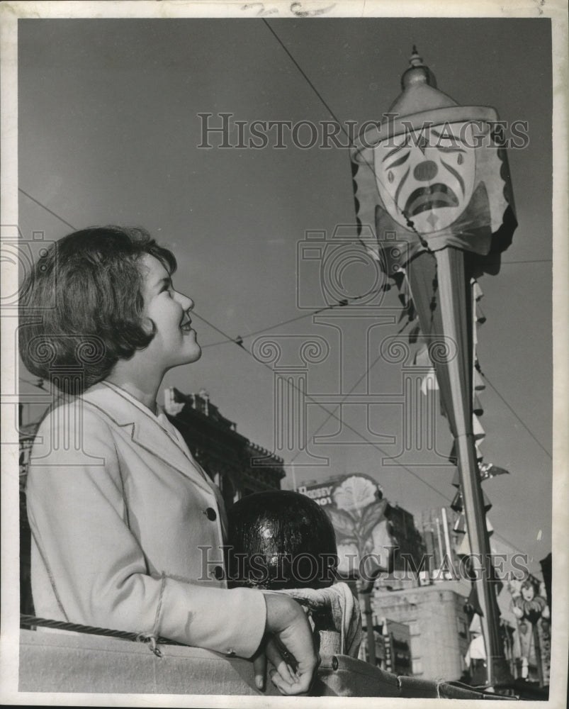 1963 Mardi Gras decorations atop light standard on Canal. - Historic Images