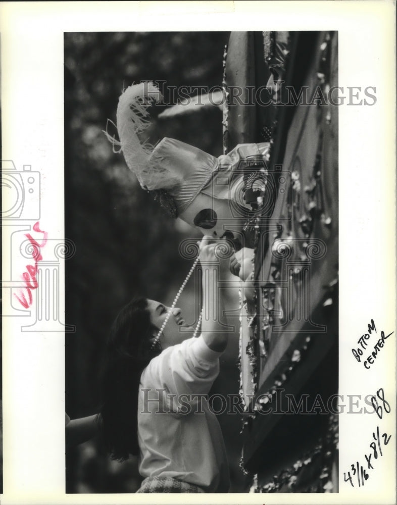 1990 Carnival reveler tries to make a deal for beads.  - Historic Images