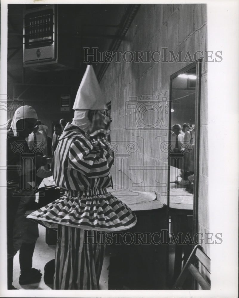 1963 Carnival float rider adjusts mask in Rex den 1962  - Historic Images