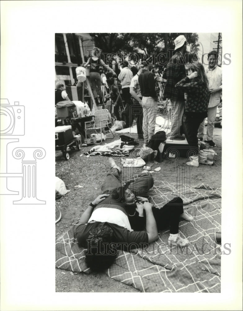 1991 Mardi Gras, New Orleans Carnival spectators take a nap. - Historic Images