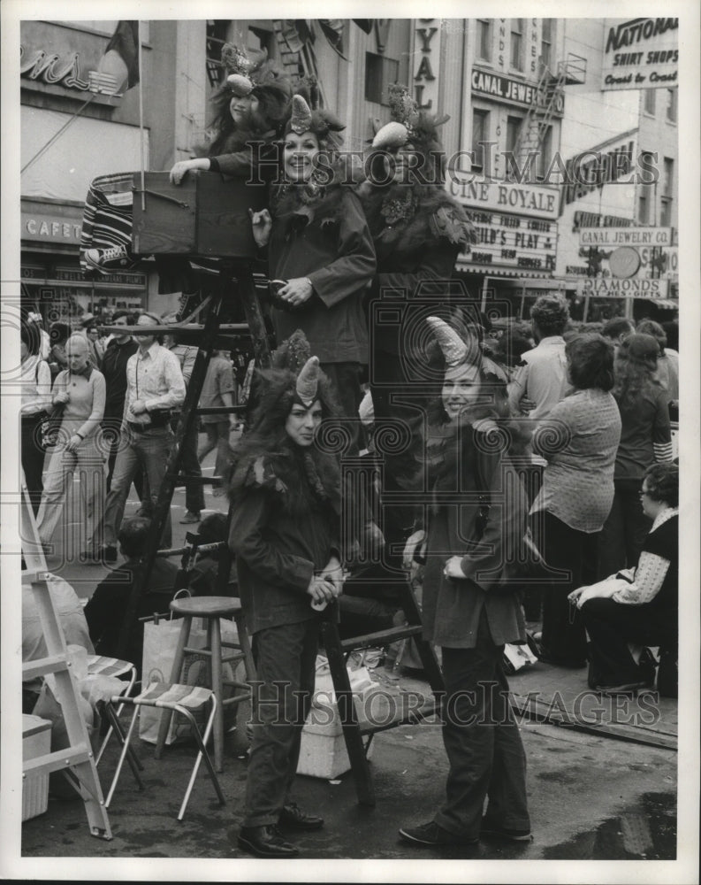 1973 Carnival maskers pose on ladders for photographer  - Historic Images