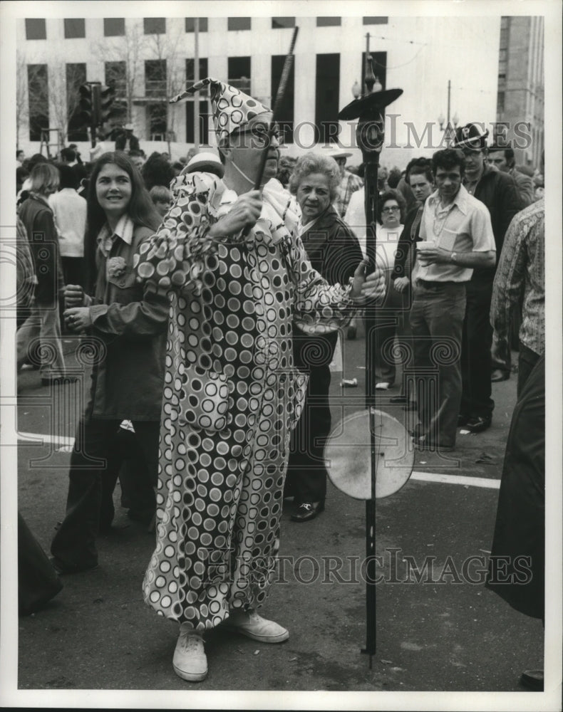1973 Carnival Clown masker performs for crowds.  - Historic Images