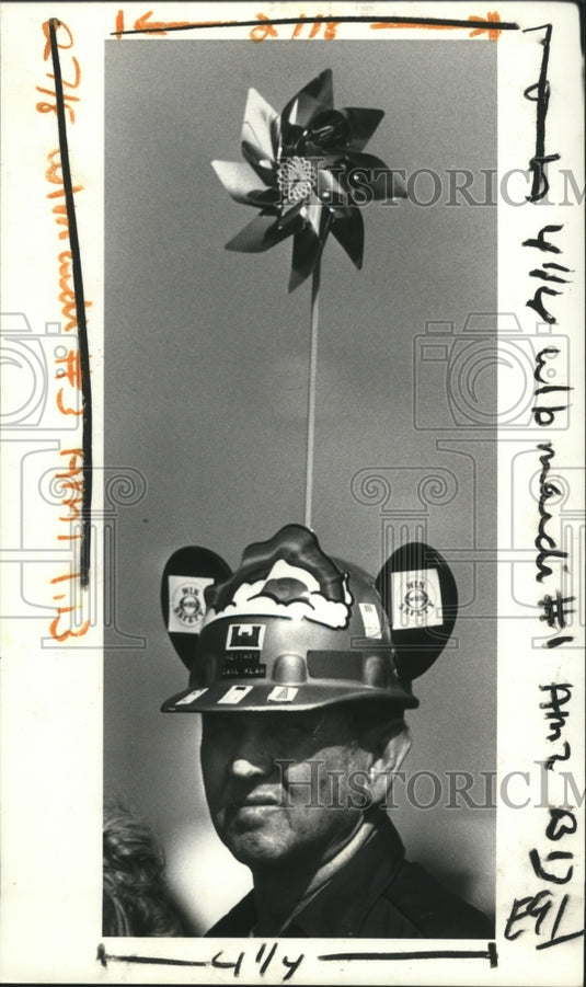 1983 Earl Klar sports a pinwheel hat as he waits for parades. - Historic Images