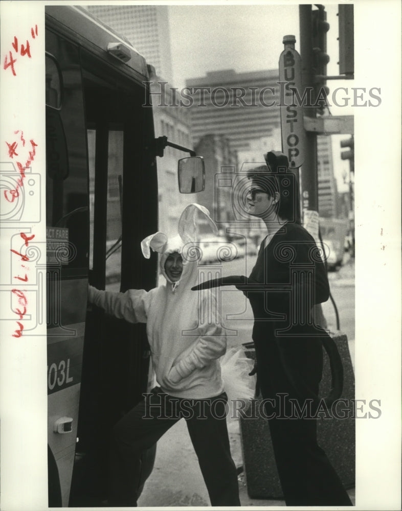 1984 Nancy Brewer (l) (the bunny) and Judy K. Nelson board a bus. - Historic Images