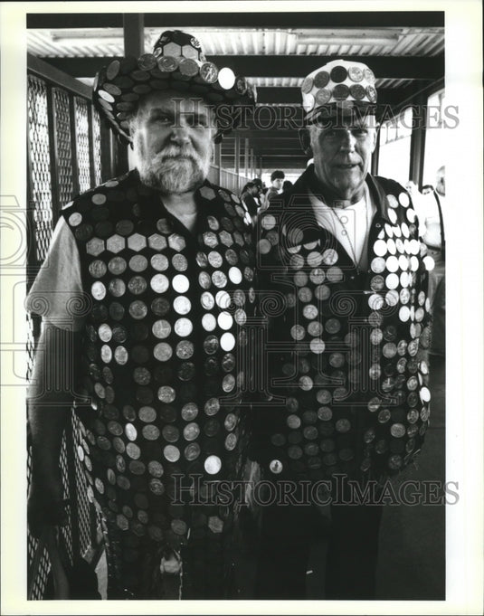 1992 Carnival maskers Leo Jenkins and Vern M Flake display dubloons. - Historic Images