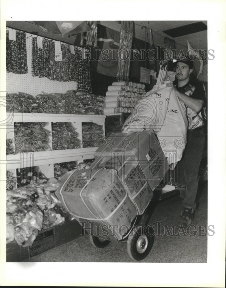 1994 Bobby Roger, Carnival Mart Employee, rolls out final selection - Historic Images