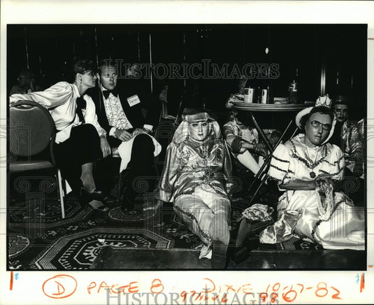 A Doctor and his wife eye the Maskers at Carnival Ball  - Historic Images