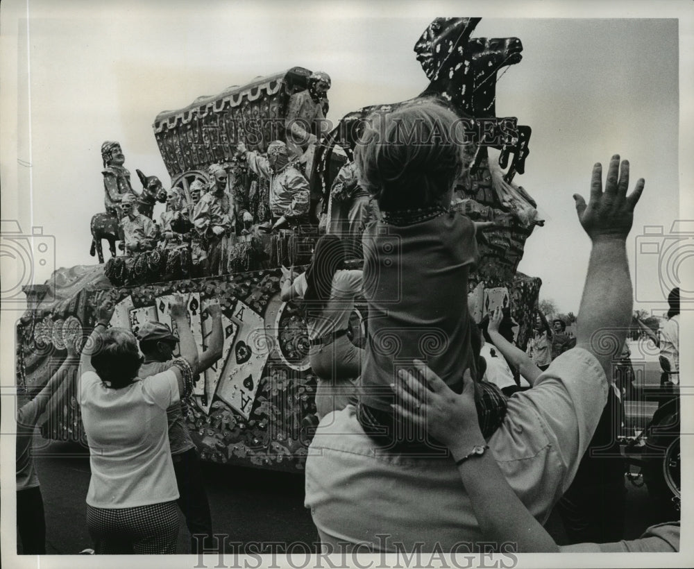 1975 spectators wave at a Carrollton parade float passing by - Historic Images