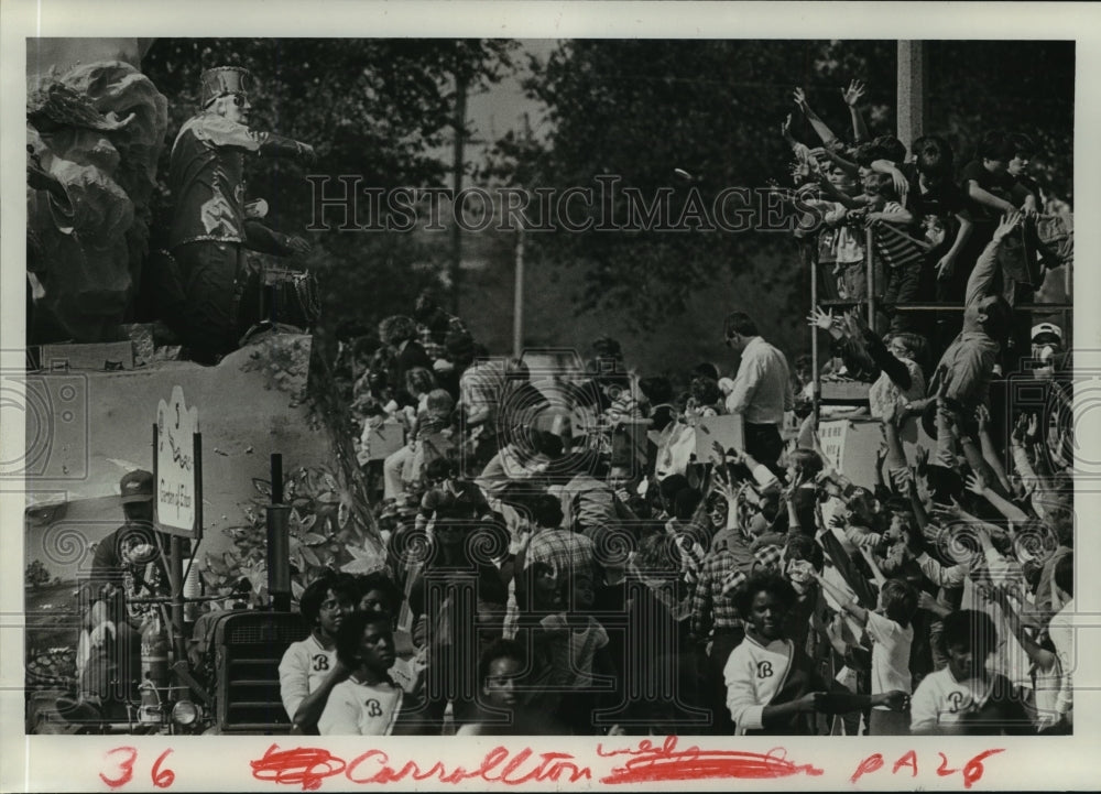 1985 hands raise up to catch the throws from the Carrollton Parade - Historic Images