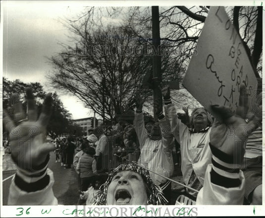 1987 Terry Shelvon uses a sign to ask for beads or cups, Mardi Gras - Historic Images