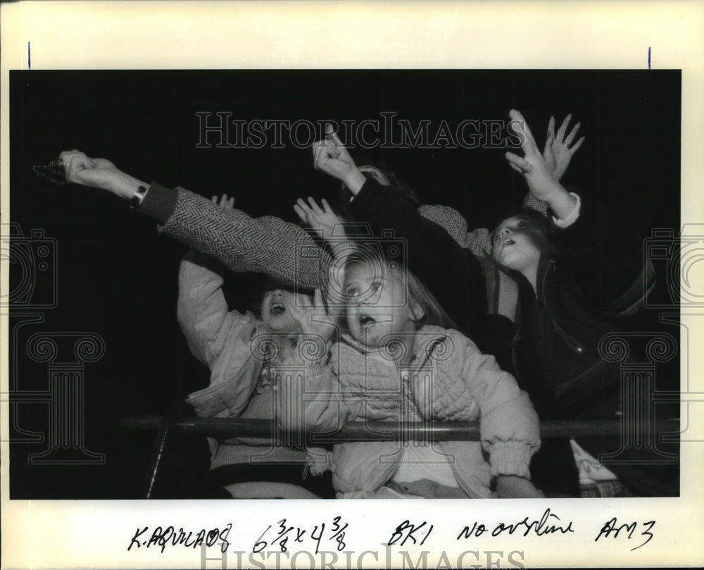 1991 Mother and Children Read for Beads from Krewe of Aquila - Historic Images