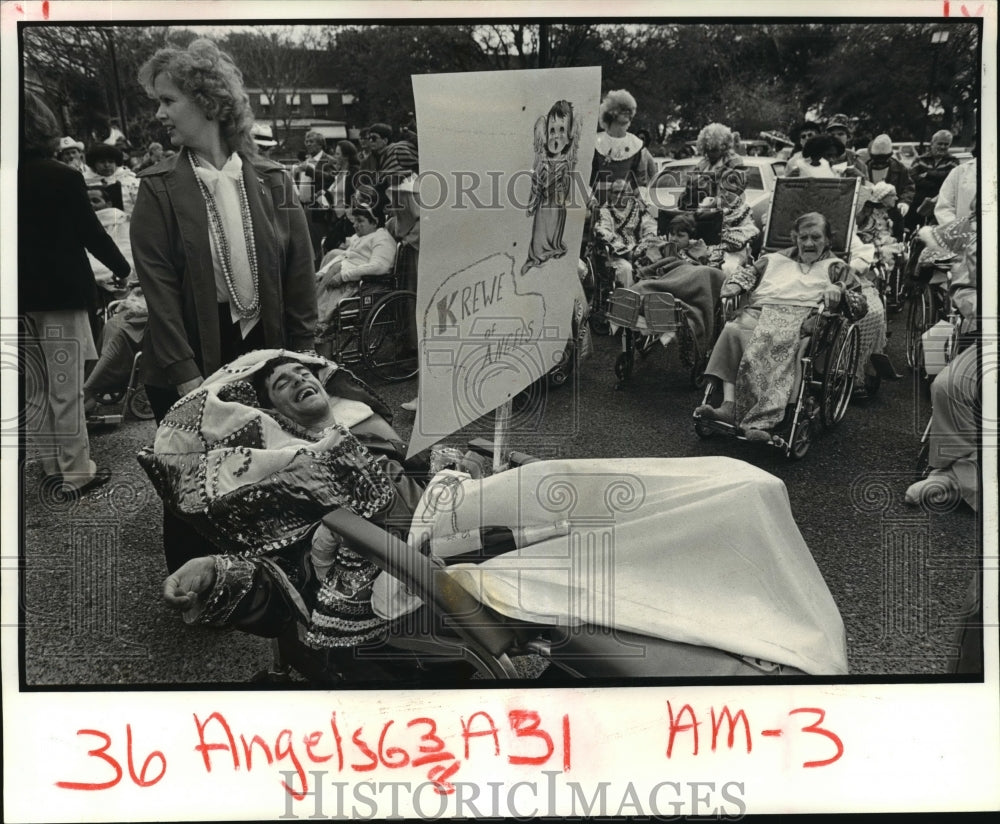 1985 Tyrone Bergeron takes a break at the Krewe of Angels parade - Historic Images