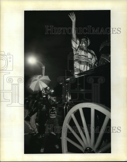 1996 Krewe of Ahsanti Member Throws to Crowd at Carnival Parade - Historic Images
