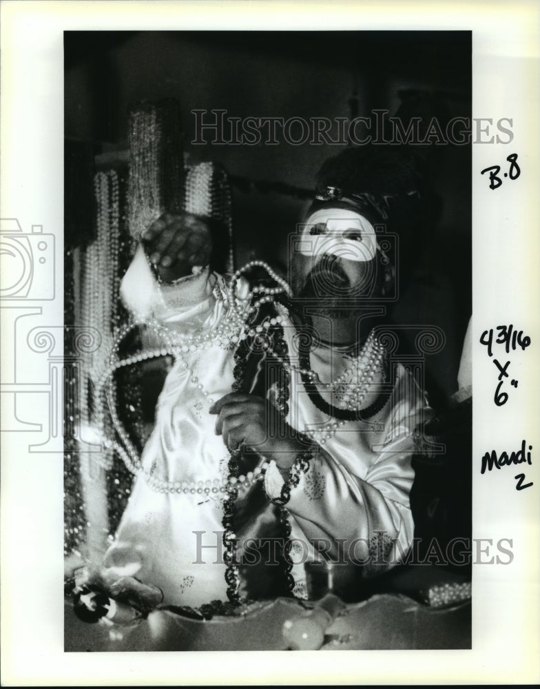 1993 Man of Krewe of Centrions Throws Beads on Streets, Mardi Gras - Historic Images