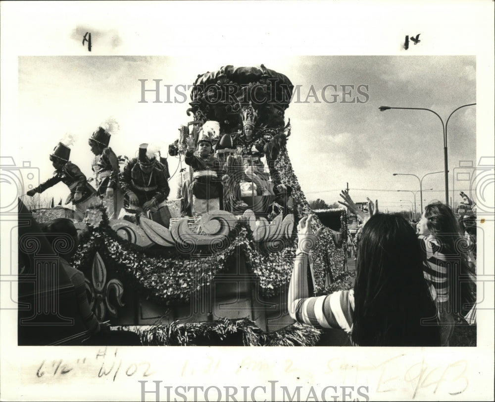 1983 Beads sail as Krewe of Oz parade passes through on Mardi Gras - Historic Images