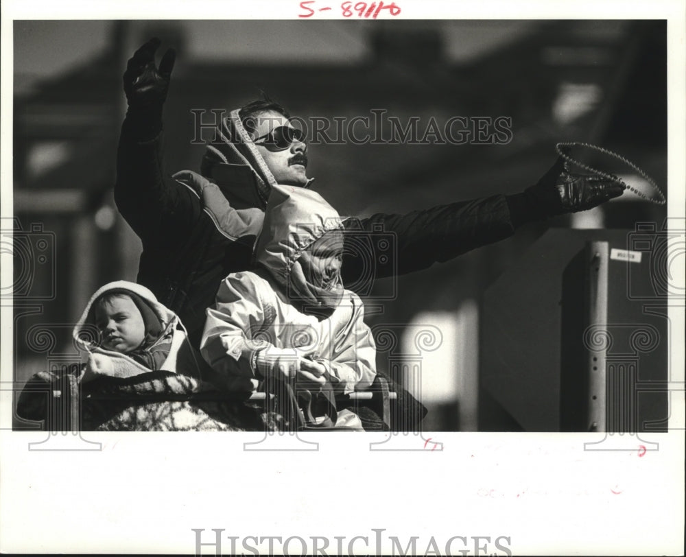 1988 Ned Couret catches beads at the Pandora Mardi Gras parade - Historic Images