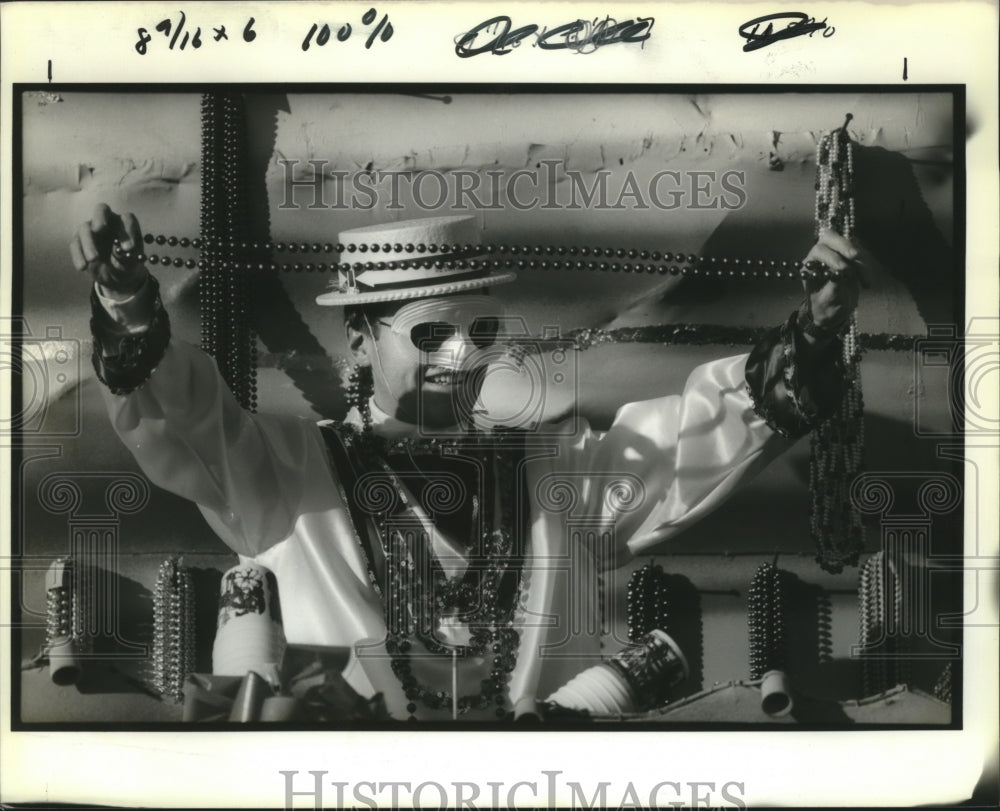 1991 Rider Teases Crowd with Beads at Mercury Parade Mardi Gras - Historic Images