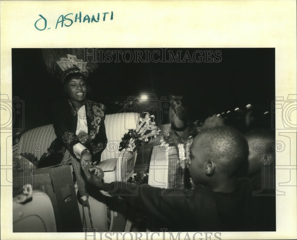 1996 Ashanti Krewe Member Diane Williams Hands Throws at Parade - Historic Images