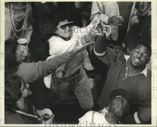 1990 Bourbon St. Spectators Fight for Beads at Mardi Gras - Historic Images