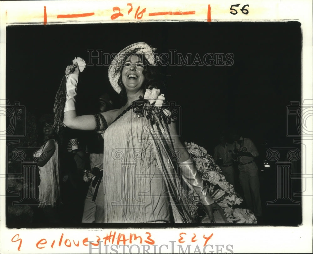 1982 Krewe of Love Member Throwing Flowers Before Carnival Parade - Historic Images