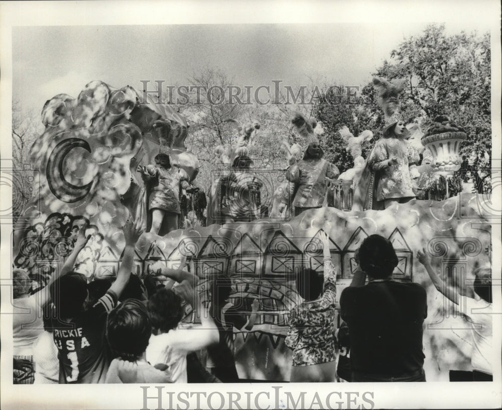 1975 Maskers of Float in Parade from Krewe of Mokana at Mardi Gras - Historic Images