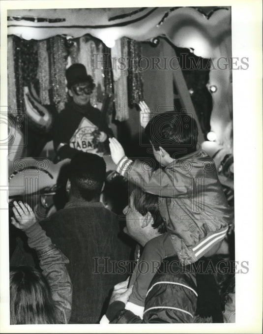 1991 Micha McHugh Reaches for Throws at Krewe of Eve Carnival Parade - Historic Images