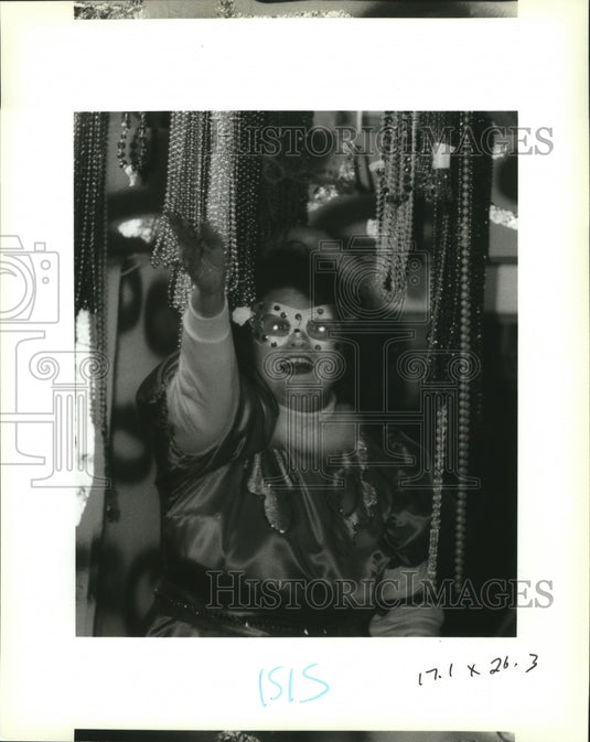 1993 Rider Throws Beads at Krewe of Isis Parade at Mardi Gras - Historic Images