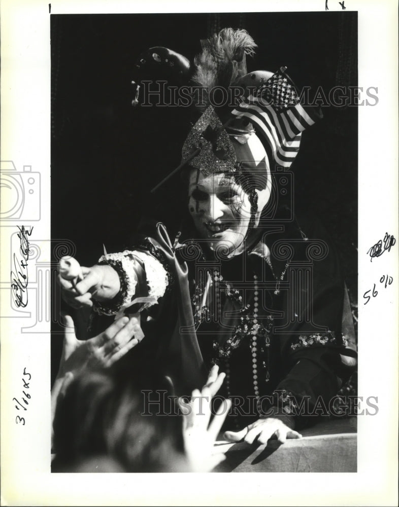 1991 Krewe of Flora Member Handing Rose to Crowd in Carnival Parade - Historic Images