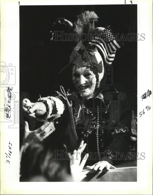 1991 Krewe of Flora Member Handing Rose to Crowd in Carnival Parade - Historic Images