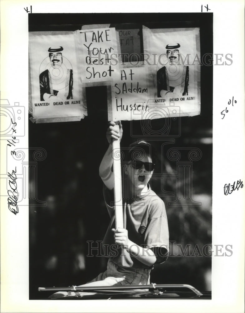 1991 Adam Smith Holding Saddam Hussein Sign in Flora Carnival Parade - Historic Images