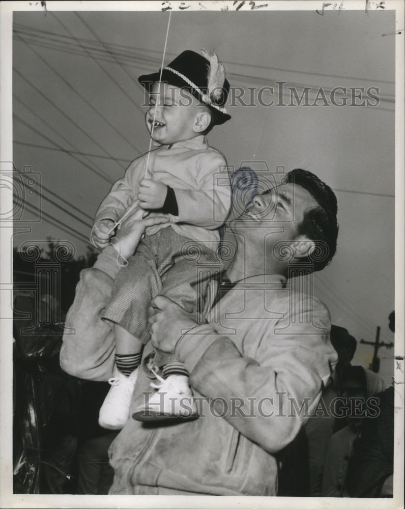 1959 Press Photo Man Carrying Mark Bascle at Carrollton Carnival Parade - Historic Images