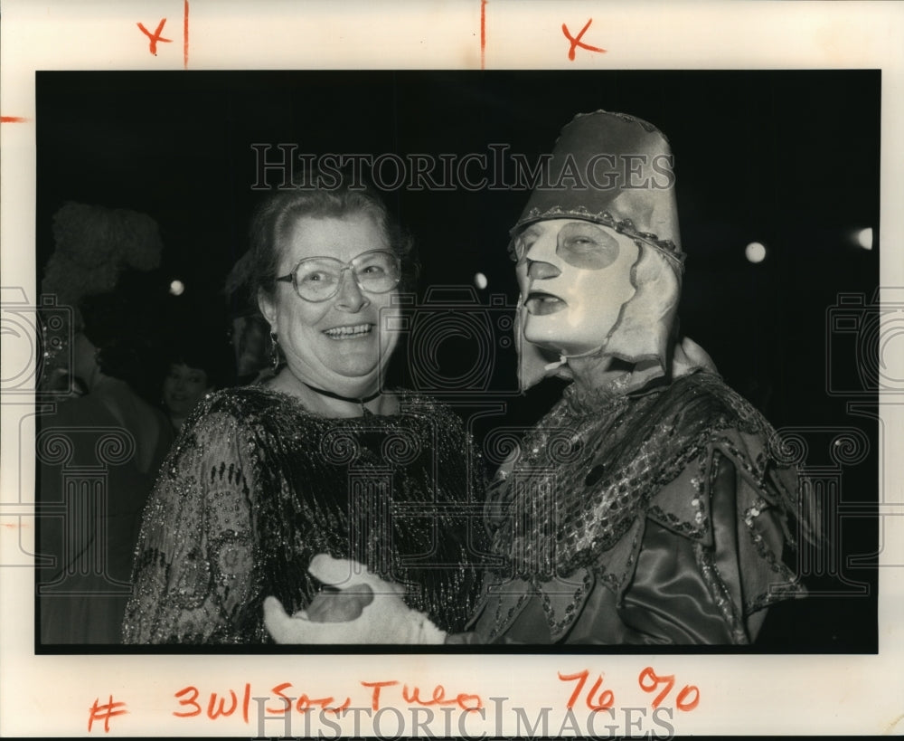 1991 Marilyn Ewin with a masker at the Momus Ball on Mardi Gras - Historic Images