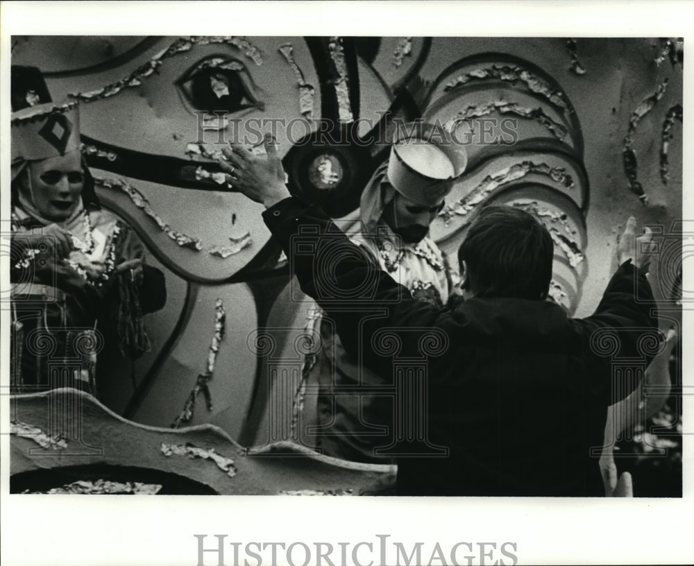 1982 Spectator Raises Arms for Beads from Krewe Okeanos Masker - Historic Images