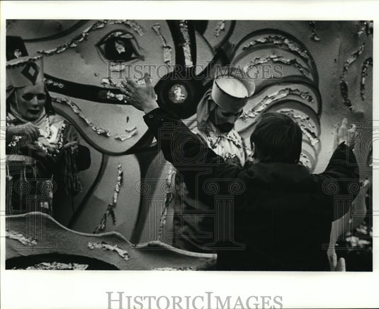 1982 Spectator Raises Arms for Beads from Krewe Okeanos Masker - Historic Images