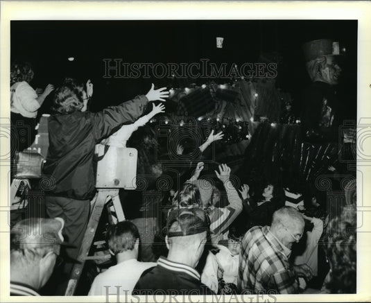 1990 Crowd Reaches for Cup From Krewe of Aquila Parade Float - Historic Images
