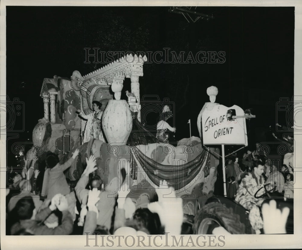 1960 Carnival Parade Float Spell of the Orient maskers toss throws. - Historic Images