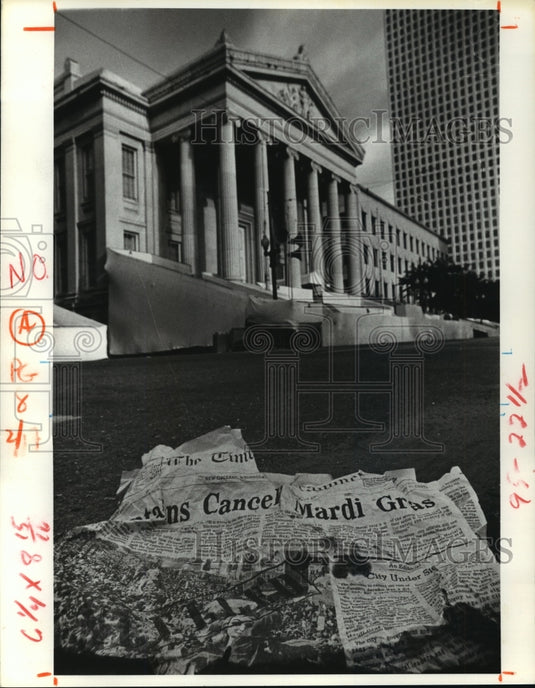 1980 torn newspaper on the street of New Orleans on Mardi Gras - Historic Images