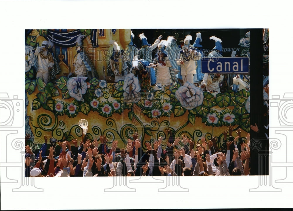 Crowds reach up at a Mardi Gras parade float on Canal Street - Historic Images