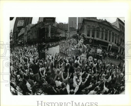 1993 Krewe of Rex parade passes revelers on the street on Mardi Gras - Historic Images