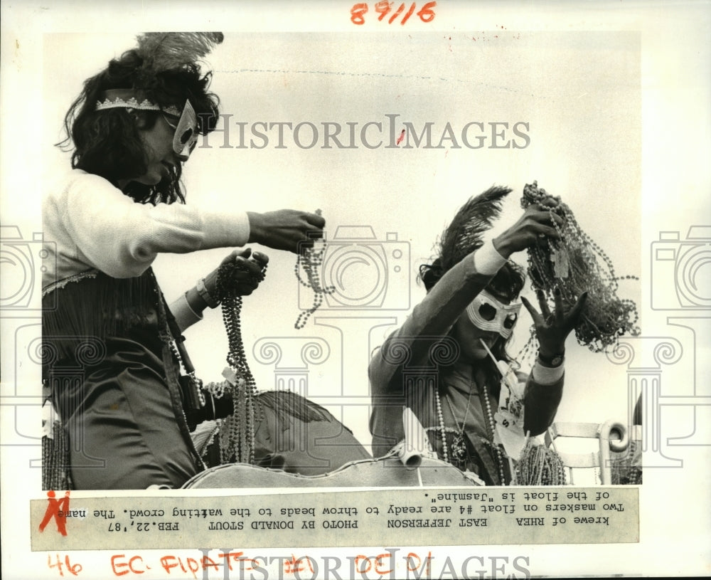 1987 Maskers on a Krewe of Rhea parade float on Mardi Gras - Historic Images