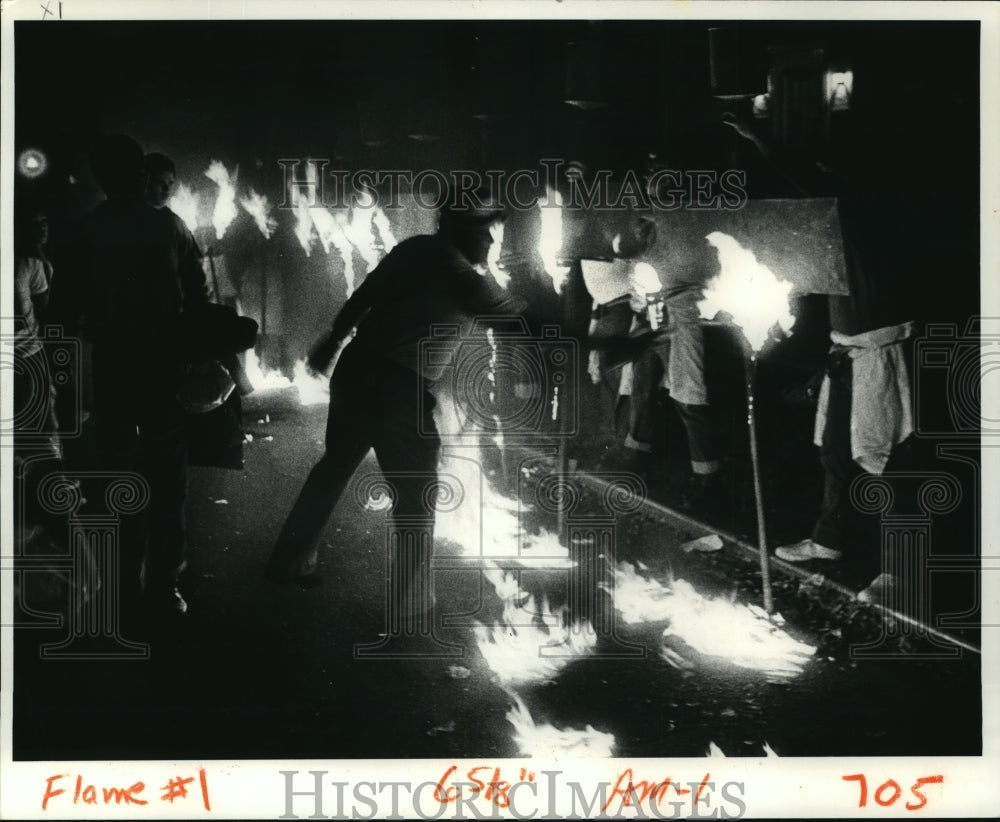 1982 Frank Lazard Lights Flambeaux for Babylon at Mardi Gras - Historic Images