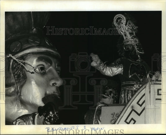 1996 Gladiators parade captain throws beads from float on Mardi Gras - Historic Images